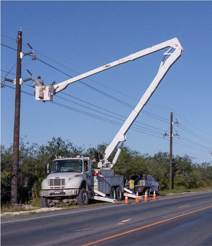 utility truck and bucket extended and lineman working on power line