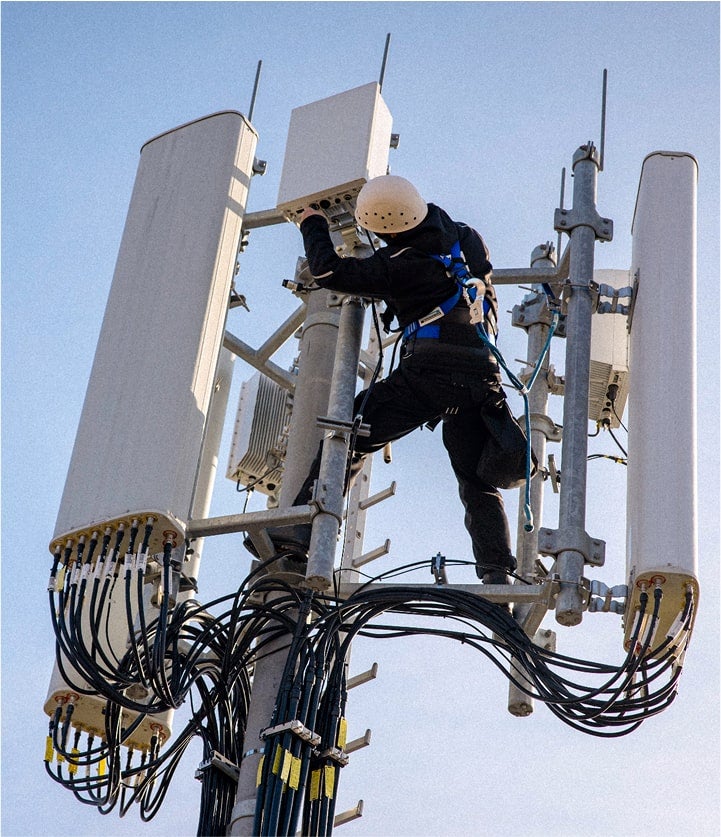 telecom worker working on a cell tower